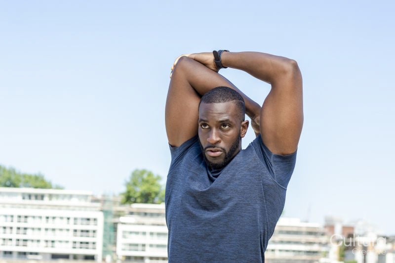 Mid adult man stretching in urban setting