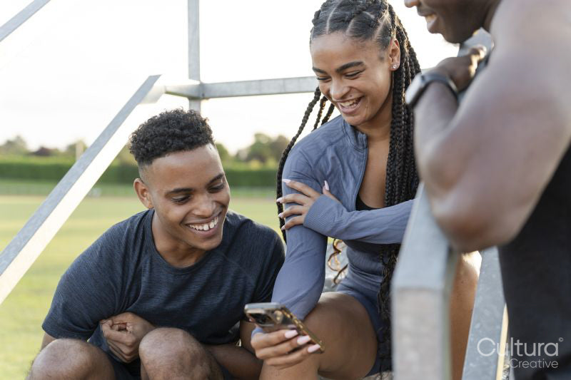 Group of athletes sitting on steps at stadium