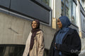Two young women walking in street