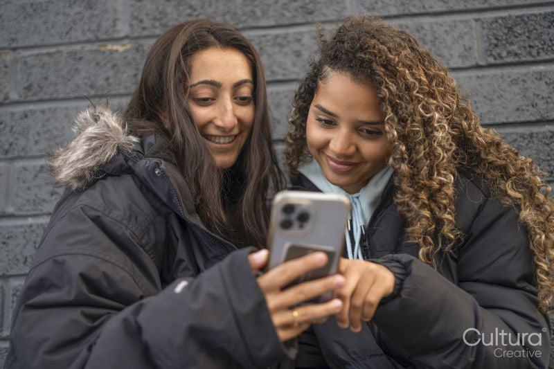Two young women looking at smartphone