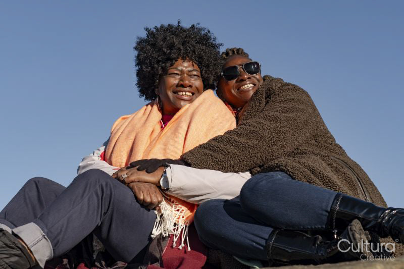 Portrait of two senior women under blue sky