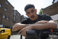 Portrait of man leaning on bikes handlebar
