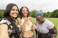 Portrait of three friends laughing in park