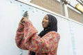 Smiling young woman wearing hijab taking selfie
