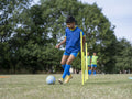 Children dressed in uniforms practicing on soccer field