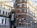 Portrait of man using smart phone in city street