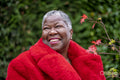 Portrait of senior woman wearing red fur coat