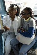 Young female couple riding city bus