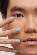 Studio portrait of handsome man with colored nails