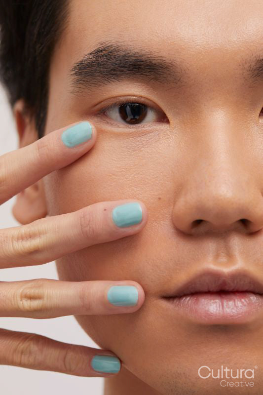 Studio portrait of handsome man with colored nails