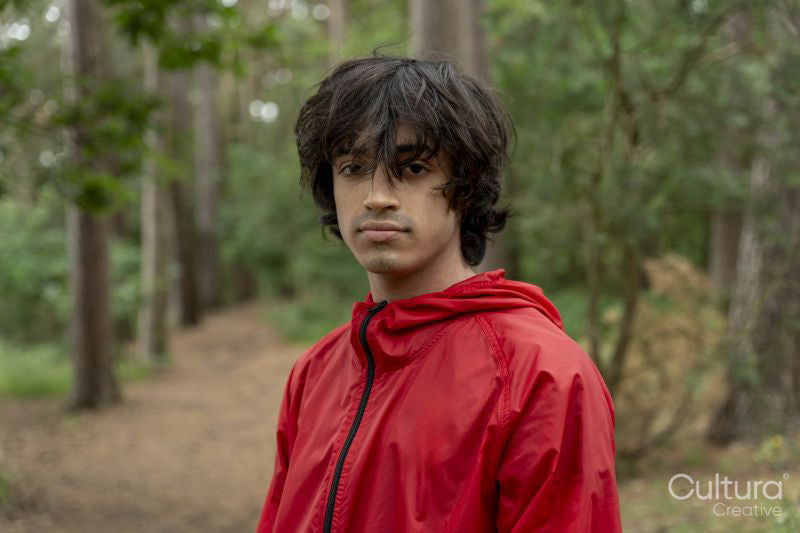 Portrait of young man hiking in forest