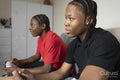 Teenage friends playing video game at home