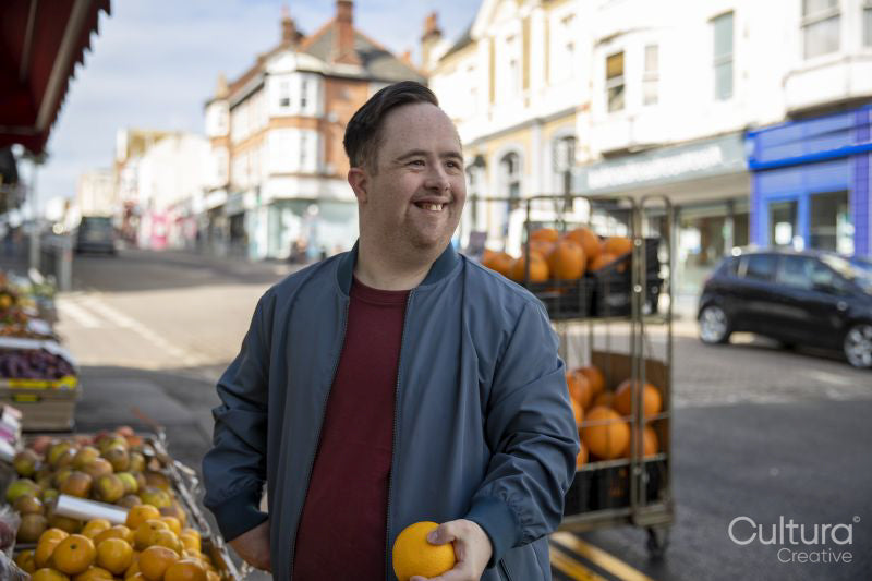 Man buying fruit in grocery store