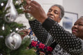 Senior couple decorating Christmas tree