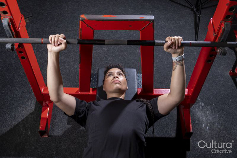 Overhead view of woman having bench press training in gym