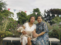 Portrait of smiling sisters holding dog