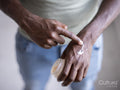 Close-up of person applying moisturizer on hand