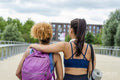 Sporty female friends embracing