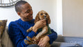 Man with dog sitting on sofa