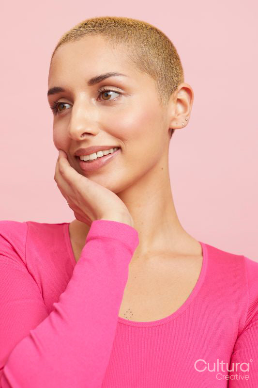 Content blond woman with hand on cheek