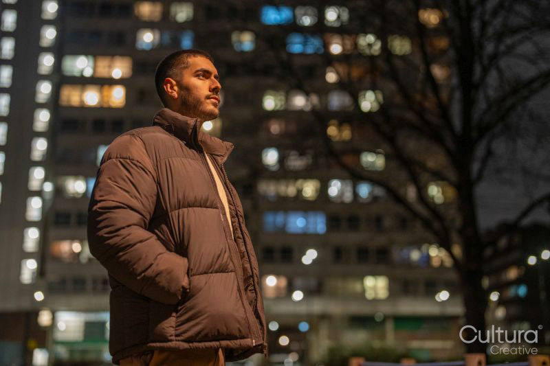 Young man standing outdoors at night