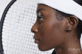 Profile of woman with tennis racket