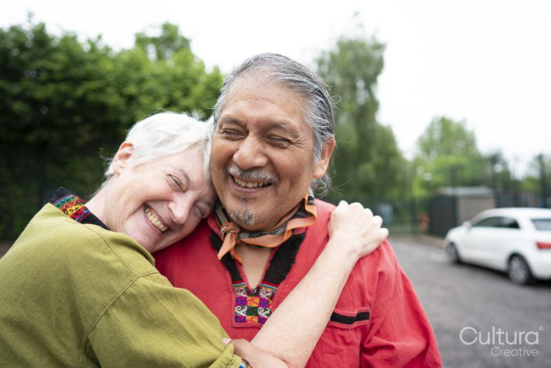 Portrait of smiling senior couple embracing outdoors