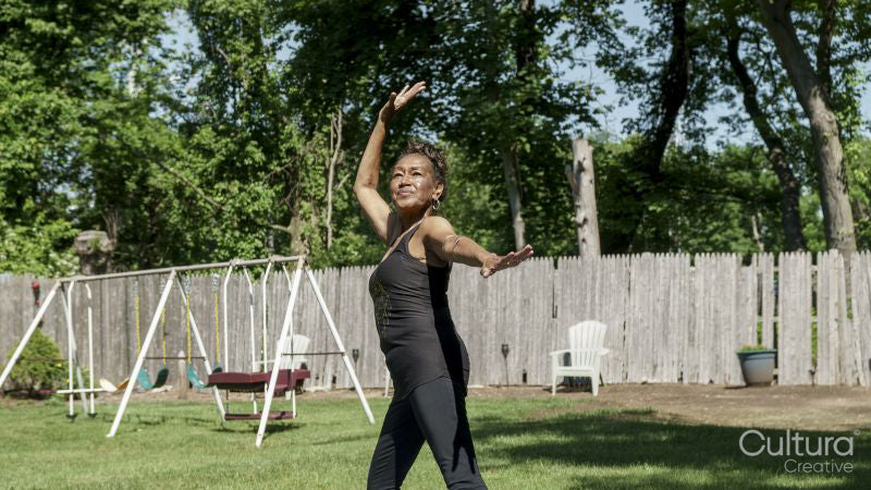 Senior woman doing yoga outdoors