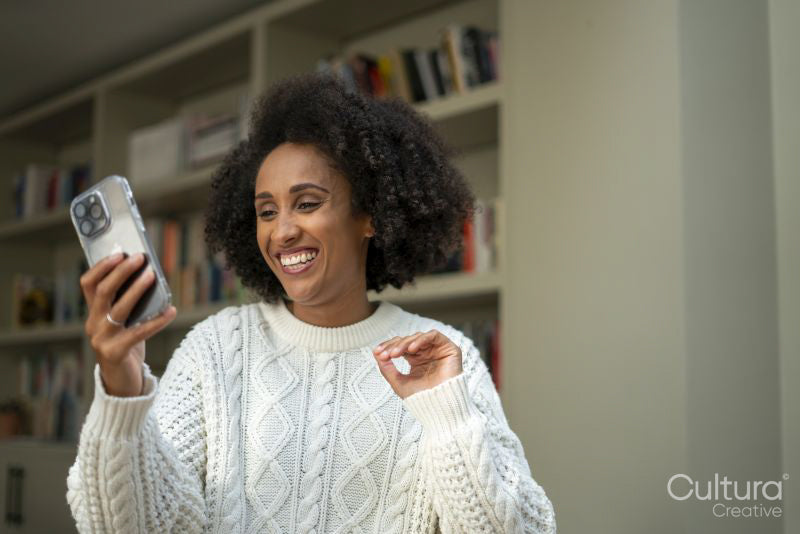Smiling woman having video call at home