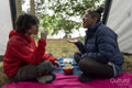 Mother and son eating snacks in tent