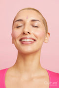 Portrait of smiling woman with short blond hair, eyes closed