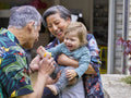 Grandparents playing with grandson outdoors