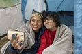Mother and son taking selfie in tent