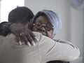 Man and woman hugging in therapy session