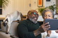 Senior couple using digital tablet at home