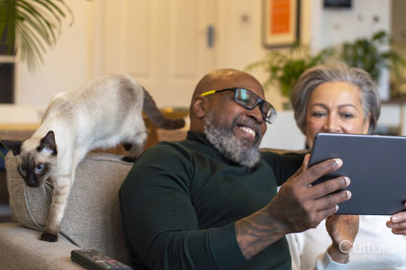 Senior couple using digital tablet at home