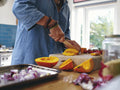 Woman chopping vegetables in kitchen,close up