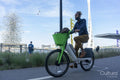 Businessman riding rental bicycle