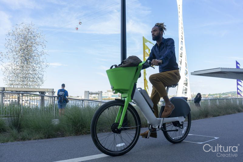 Businessman riding rental bicycle