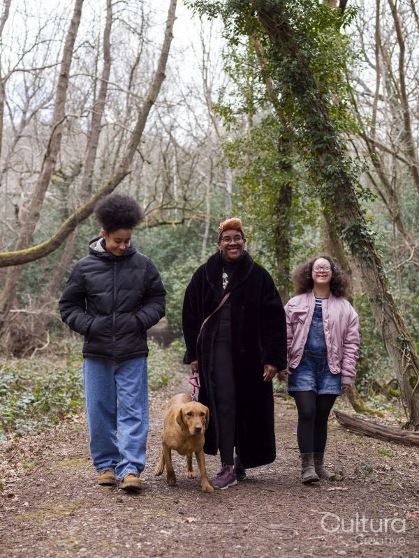 Mother with two daughters and dog in forest