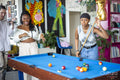 Friends playing pool together at home