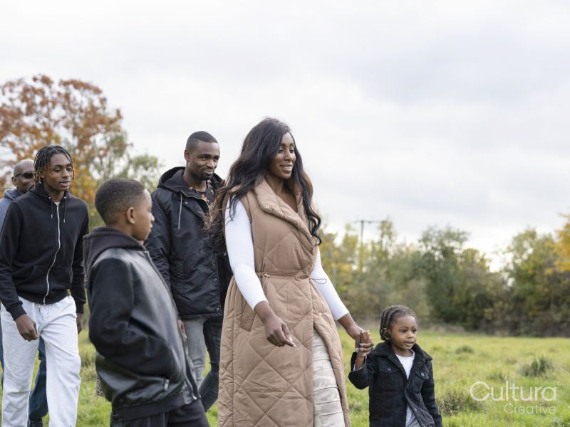 Multi-generational family walking in meadow