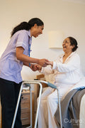 Nurse helping senior lady in her room at nursing home
