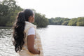 Rear view of young woman standing on lakeshore