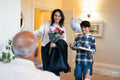Mature woman and boy arriving for birthday visit with senior man in nursing home