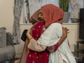 Women hugging during Ramadan celebration at home