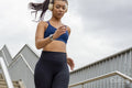 Sporty woman jogging down stairs