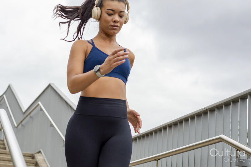 Sporty woman jogging down stairs