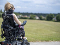 Woman in electric wheelchair going on walk