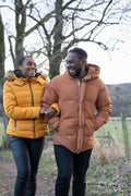 Couple in winter jackets walking in rural setting